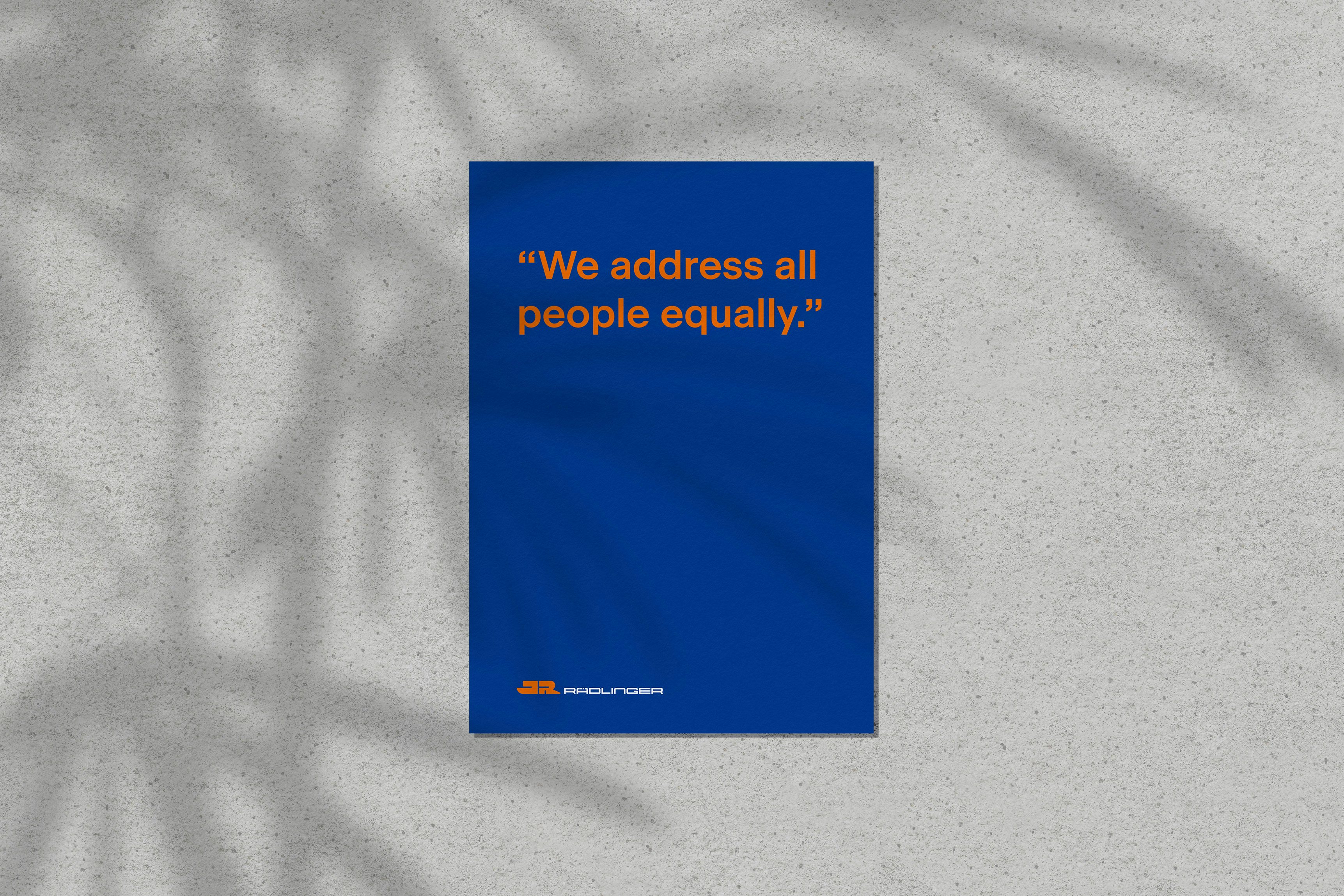 Blue sheet of paper on which is written in orange lettering, "We address all people equally."