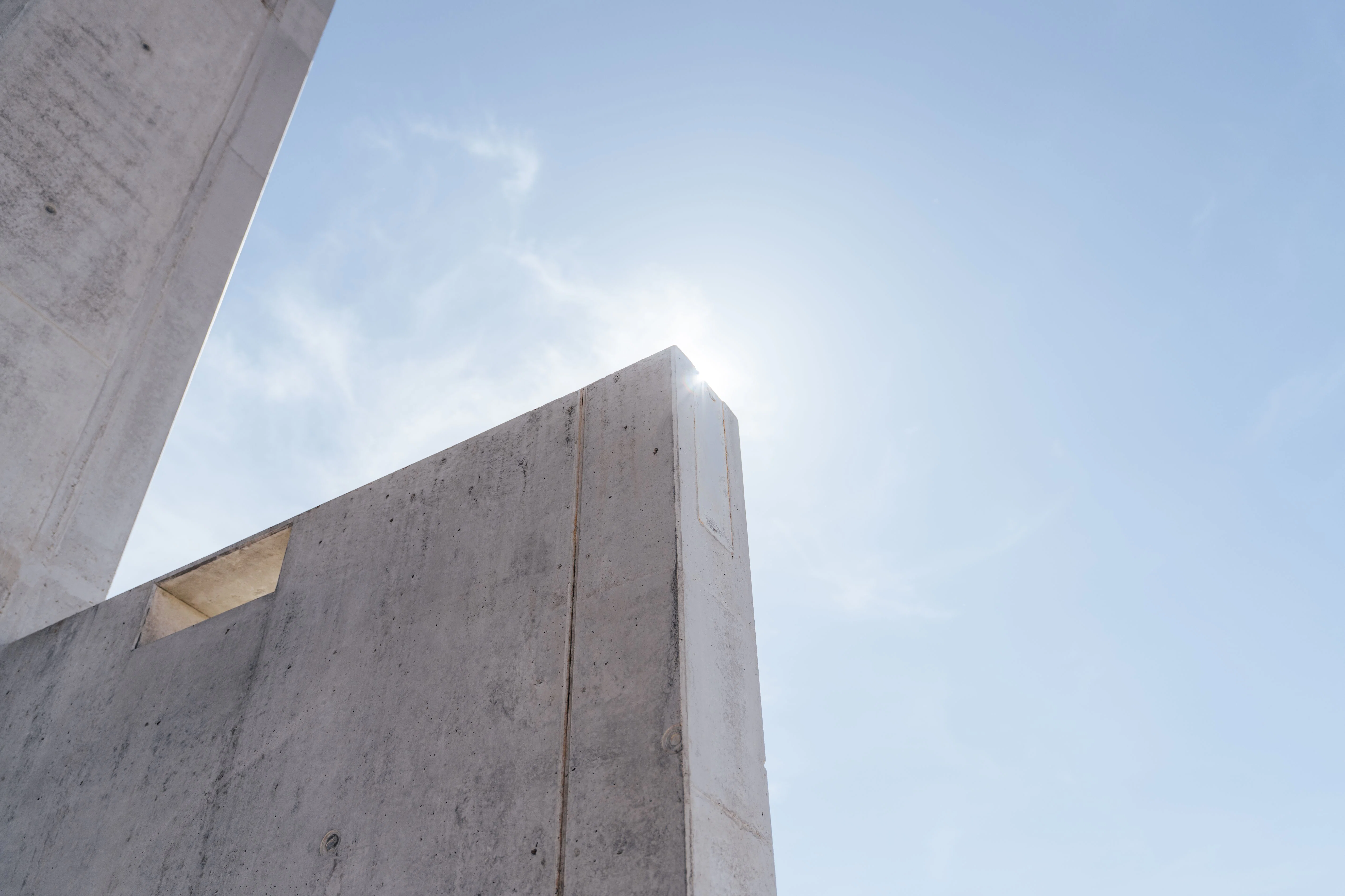 Hinter der Betonwand steigt langsam die Sonne auf