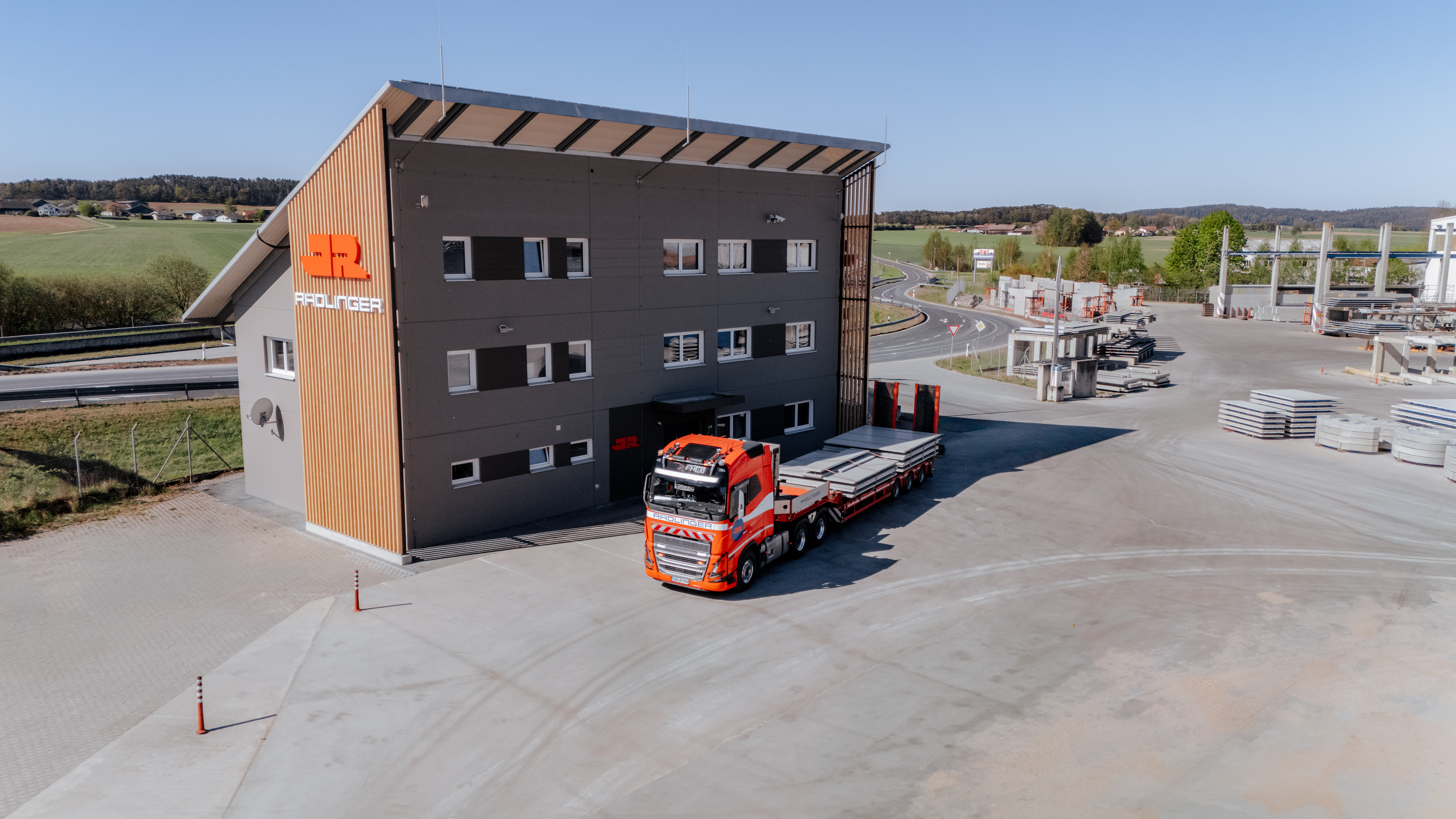 Das neu renovierte Bürogebäude am Standort der Josef Rädlinger Fertigteile GmbH mit LKW Tieflader im Vordergrund